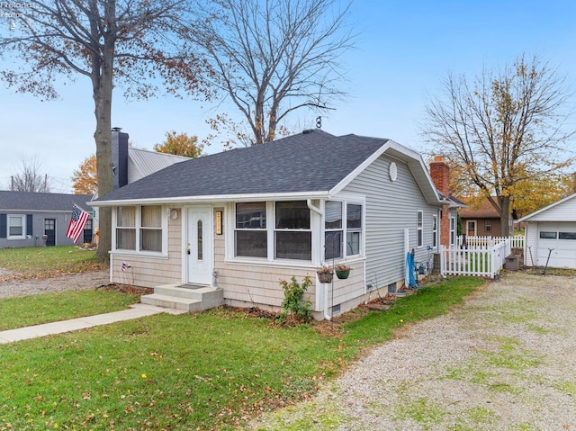 bungalow-style home with a front yard