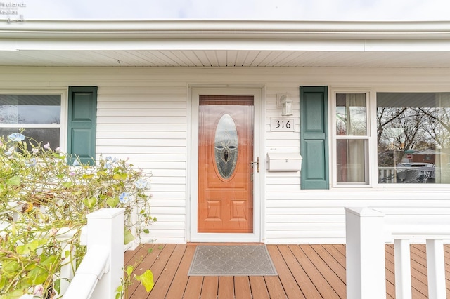 view of exterior entry featuring a porch