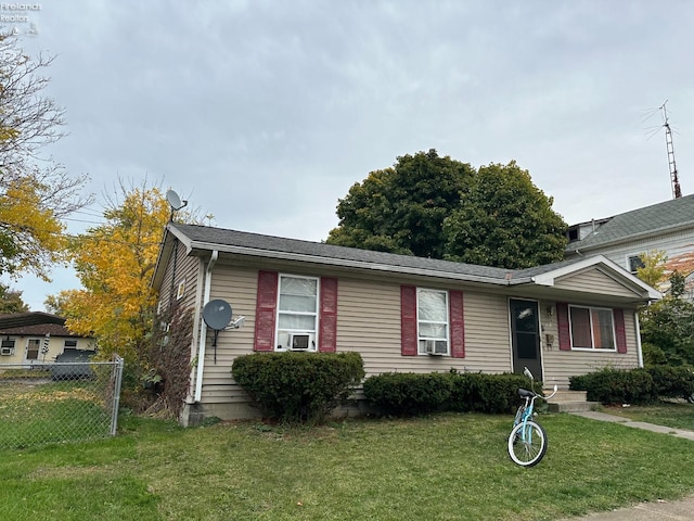 view of front of home featuring a front lawn and cooling unit