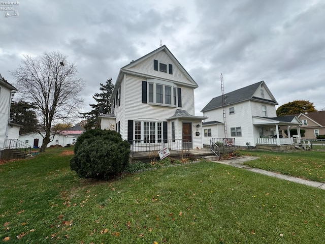 view of front of property with a front lawn and covered porch