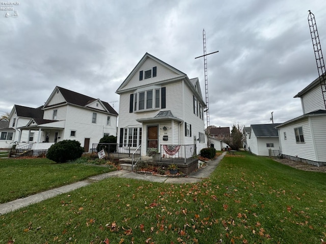 view of property featuring a front lawn