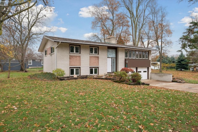 view of front of property featuring a garage and a front lawn