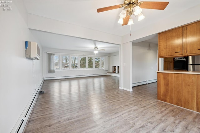 unfurnished living room featuring a wall mounted air conditioner, a baseboard radiator, and light hardwood / wood-style floors