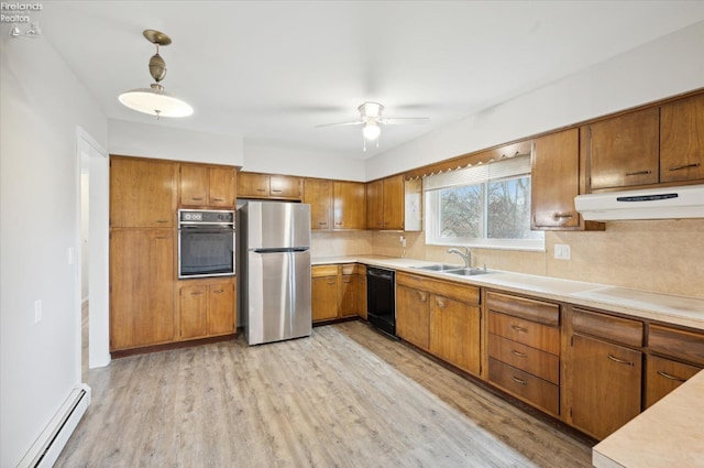 kitchen featuring light wood-type flooring, ceiling fan, a baseboard heating unit, sink, and black appliances