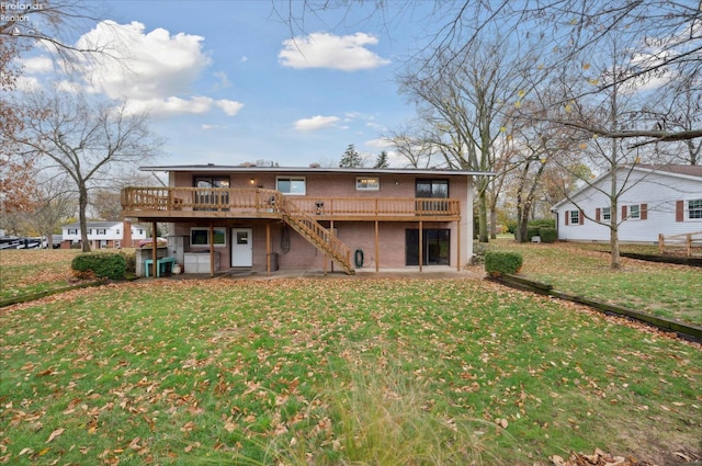 rear view of house with a lawn and a wooden deck