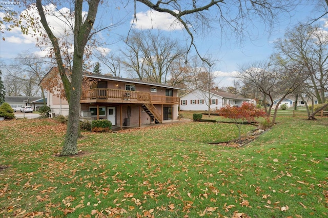 back of property featuring a wooden deck and a yard