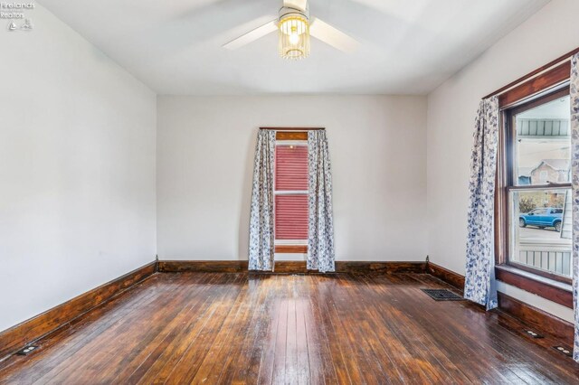 spare room featuring ceiling fan and dark hardwood / wood-style flooring