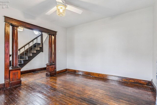 empty room featuring ceiling fan and dark wood-type flooring