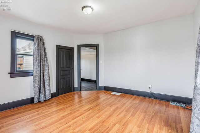 empty room with wood-type flooring