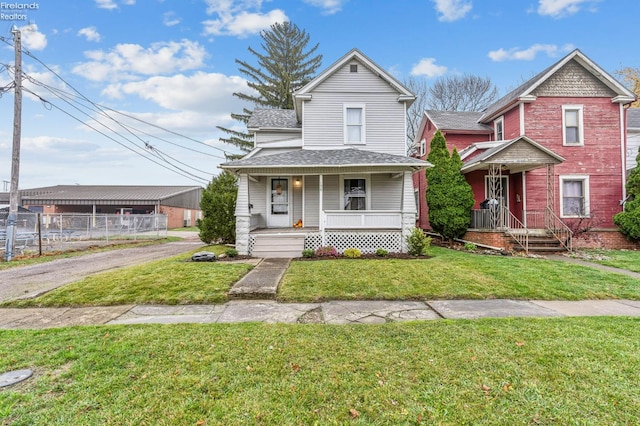 view of front of house with covered porch and a front yard