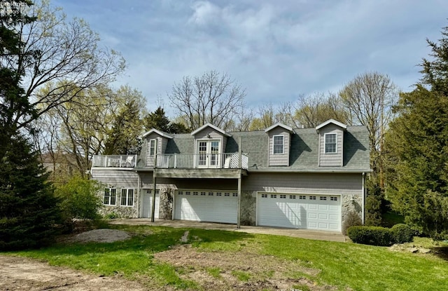 view of front of home featuring a balcony, a front lawn, and a garage