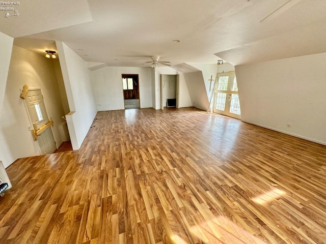 unfurnished living room featuring ceiling fan and light hardwood / wood-style floors