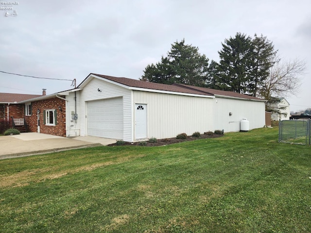 view of side of property featuring a yard and a garage