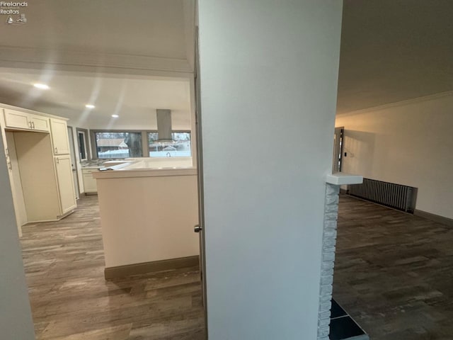 hallway with hardwood / wood-style flooring