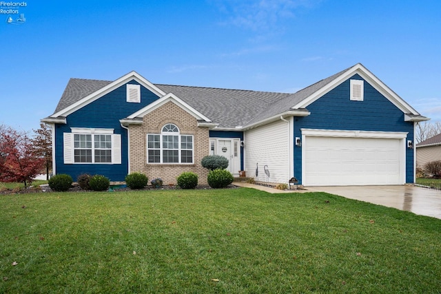 view of front of house with a front yard and a garage