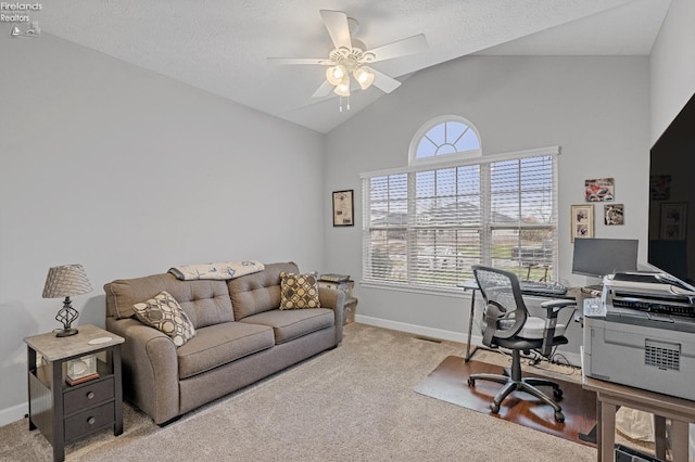 office area featuring light colored carpet, vaulted ceiling, a wealth of natural light, and ceiling fan