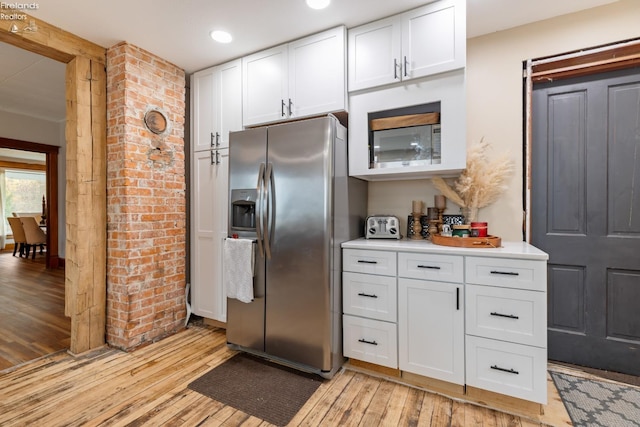 kitchen featuring light hardwood / wood-style floors, white cabinetry, and stainless steel appliances