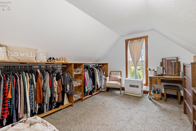 spacious closet featuring carpet flooring and lofted ceiling