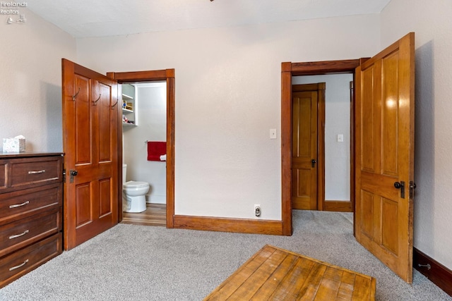 carpeted bedroom with connected bathroom