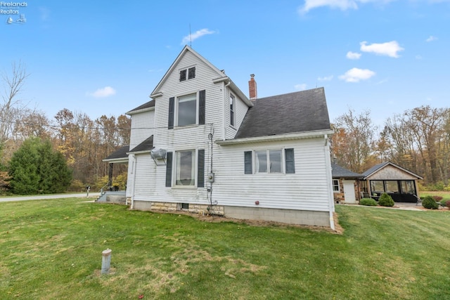 rear view of house with a yard