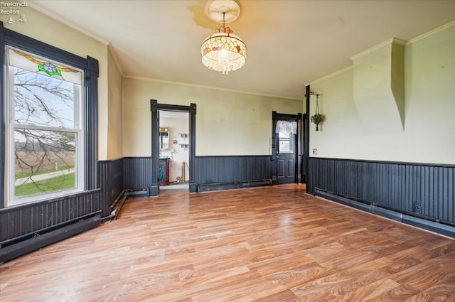 spare room with light hardwood / wood-style floors and ornamental molding