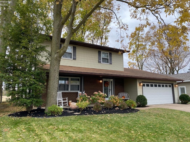 view of front of property with a front lawn and a garage