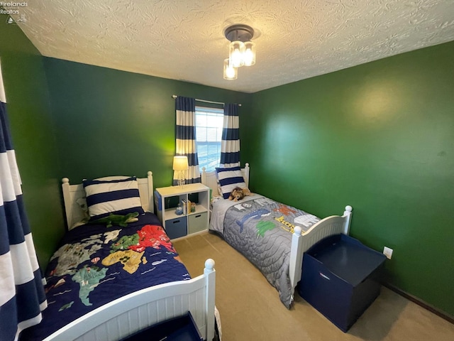 bedroom with carpet and a textured ceiling