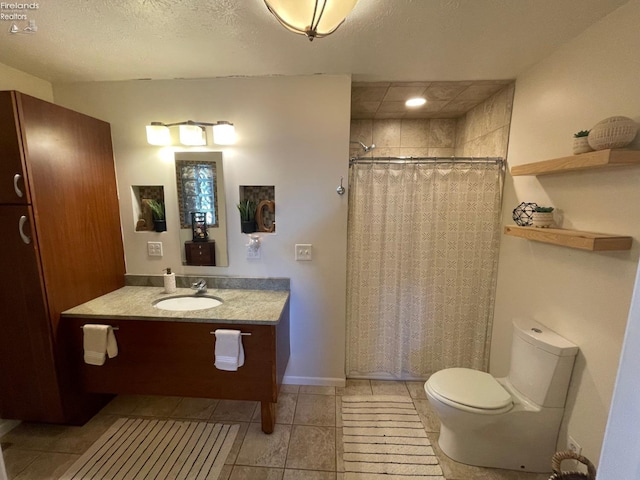 bathroom with walk in shower, tile patterned floors, a textured ceiling, toilet, and vanity