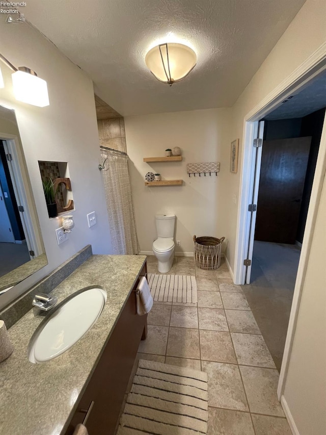 bathroom with curtained shower, tile patterned flooring, a textured ceiling, toilet, and vanity