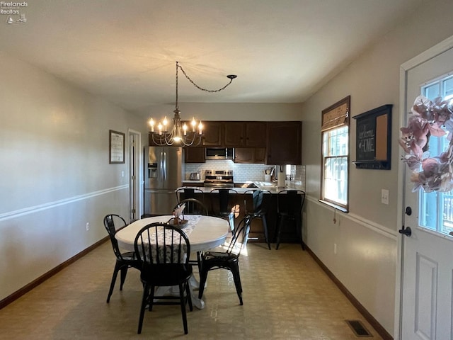 dining area with a chandelier and sink