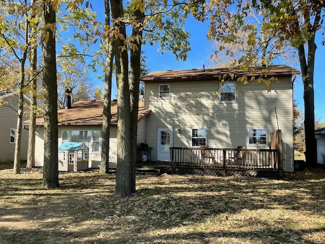 rear view of house featuring a wooden deck