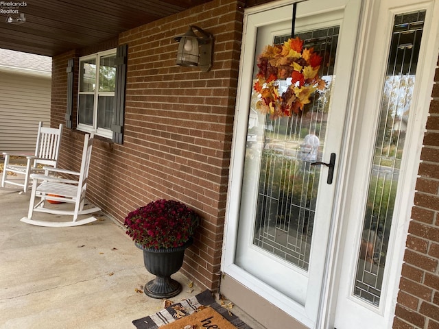 view of exterior entry featuring a porch