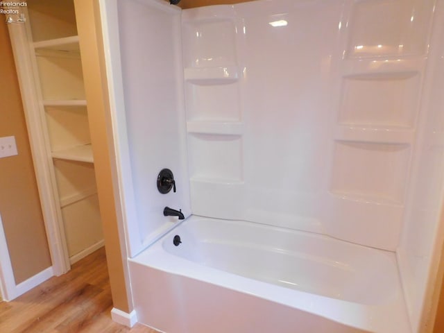 bathroom featuring shower / washtub combination and wood-type flooring