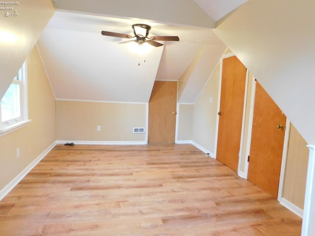 additional living space with ceiling fan, light hardwood / wood-style flooring, and lofted ceiling