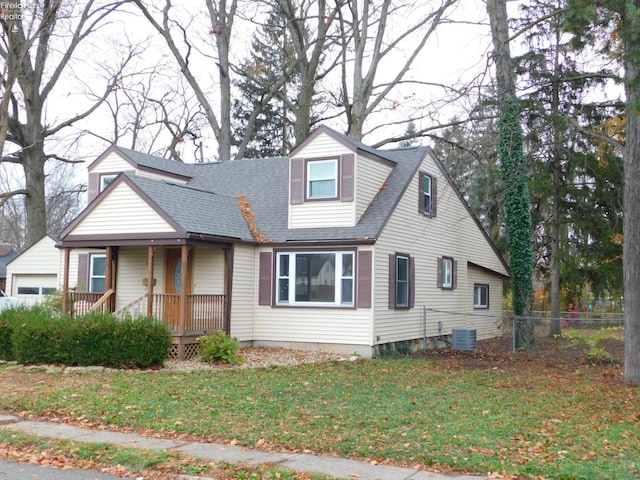 view of front of house with central AC and a front lawn