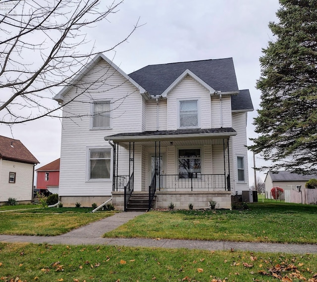 view of front of property with central AC unit, covered porch, and a front lawn