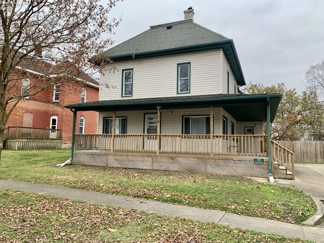 view of front of property featuring covered porch and a front yard