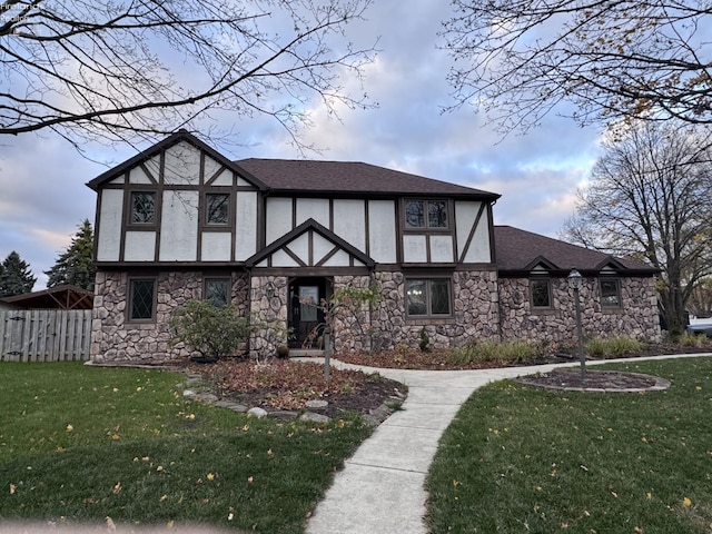 tudor-style house with a front lawn