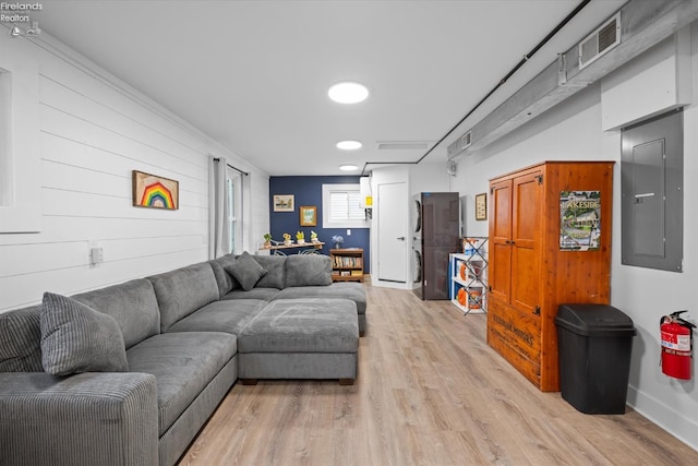 living room featuring electric panel and light hardwood / wood-style flooring