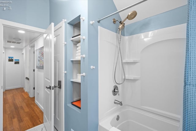 bathroom featuring shower / bathtub combination with curtain and wood-type flooring