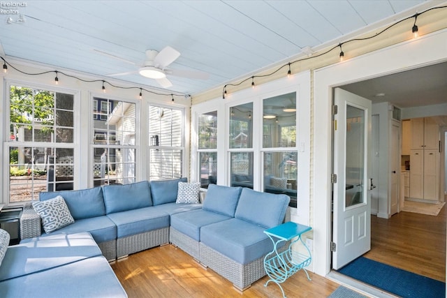 sunroom / solarium with ceiling fan and wood ceiling