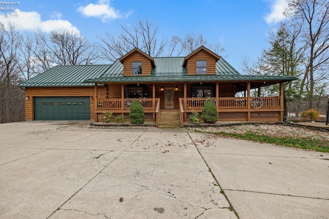 view of front of home with a porch and a garage