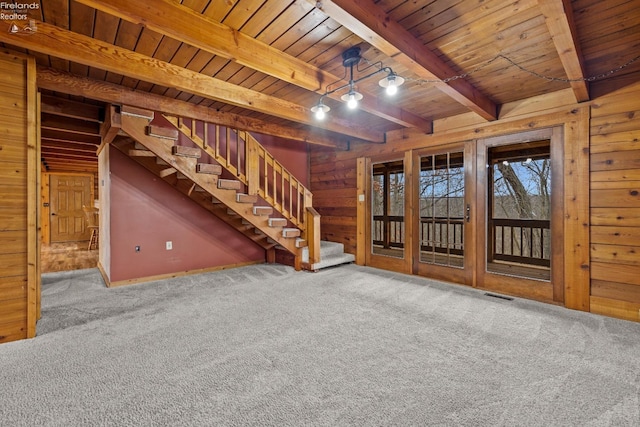 basement featuring carpet flooring, wood ceiling, and wood walls