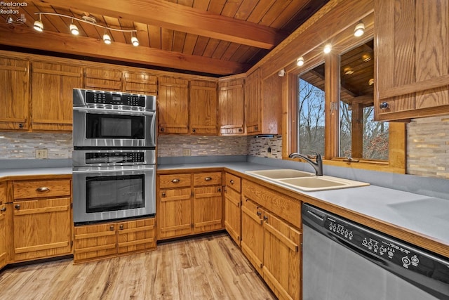 kitchen with appliances with stainless steel finishes, backsplash, wood ceiling, sink, and light hardwood / wood-style flooring