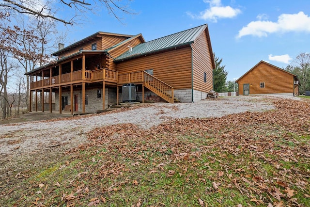 back of property featuring central AC unit and a wooden deck