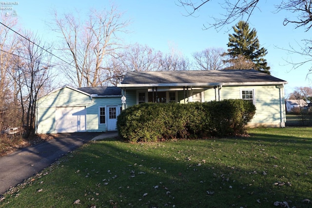 ranch-style home featuring a garage and a front lawn