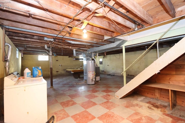 basement featuring washer and clothes dryer and water heater