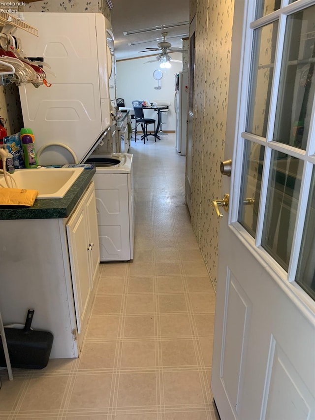 interior space featuring sink and stacked washer / dryer