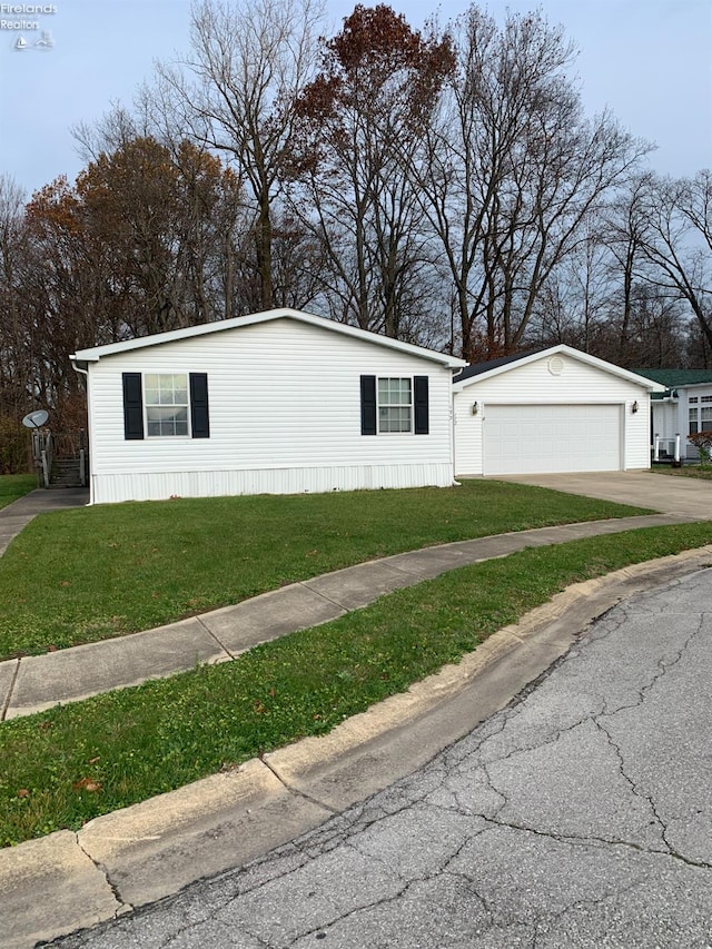 view of front of property featuring a garage and a front lawn