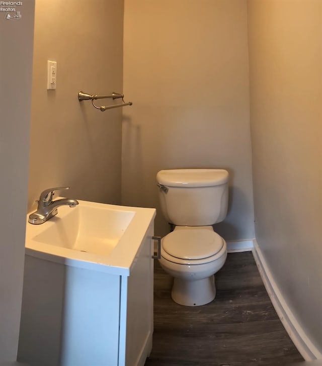 bathroom with hardwood / wood-style flooring, sink, and toilet